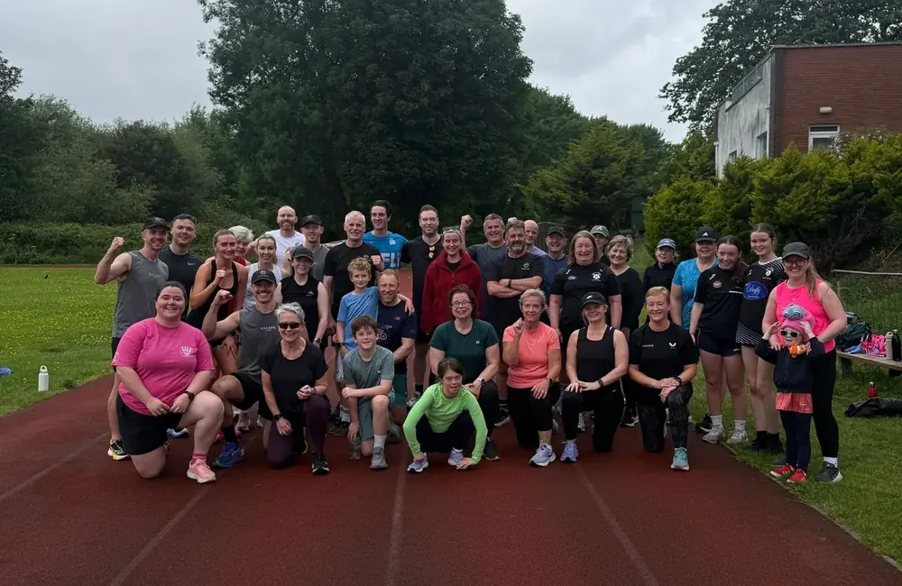 Excape run club members together on the track after a session